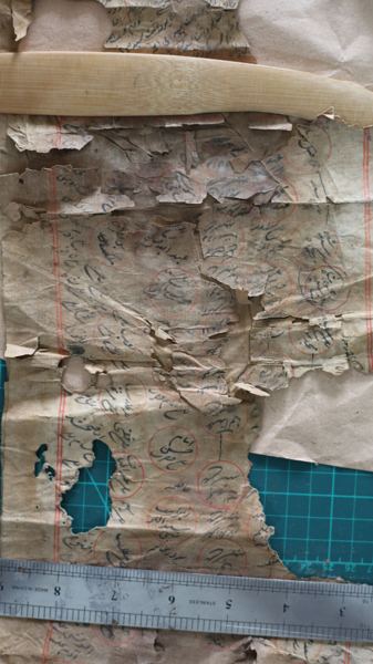 Scroll fragment, oxidised and brittle